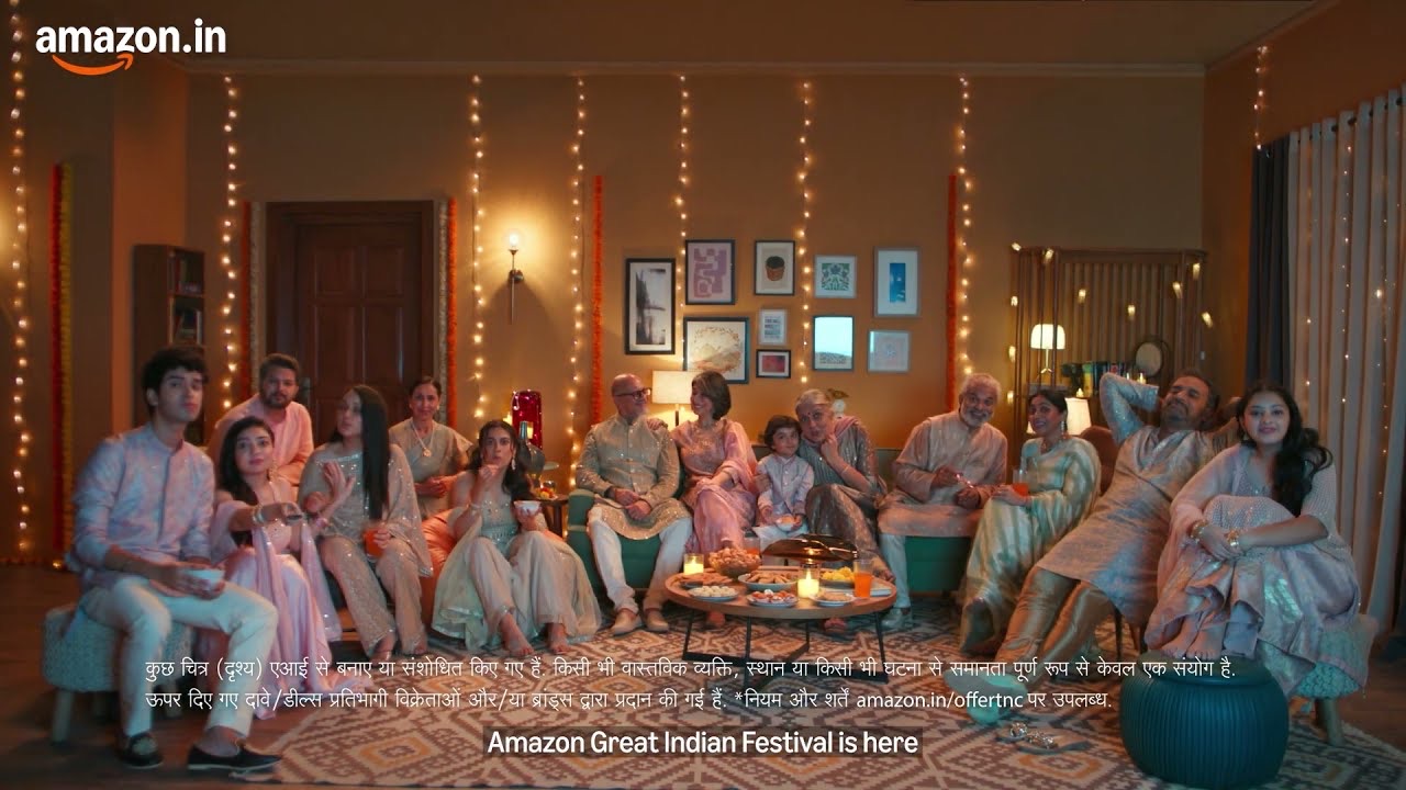 A large family in festive clothes crowds onto a sofa in a lamp-lit living room, from Amazon's Great Indian Festival 2026 TV film
