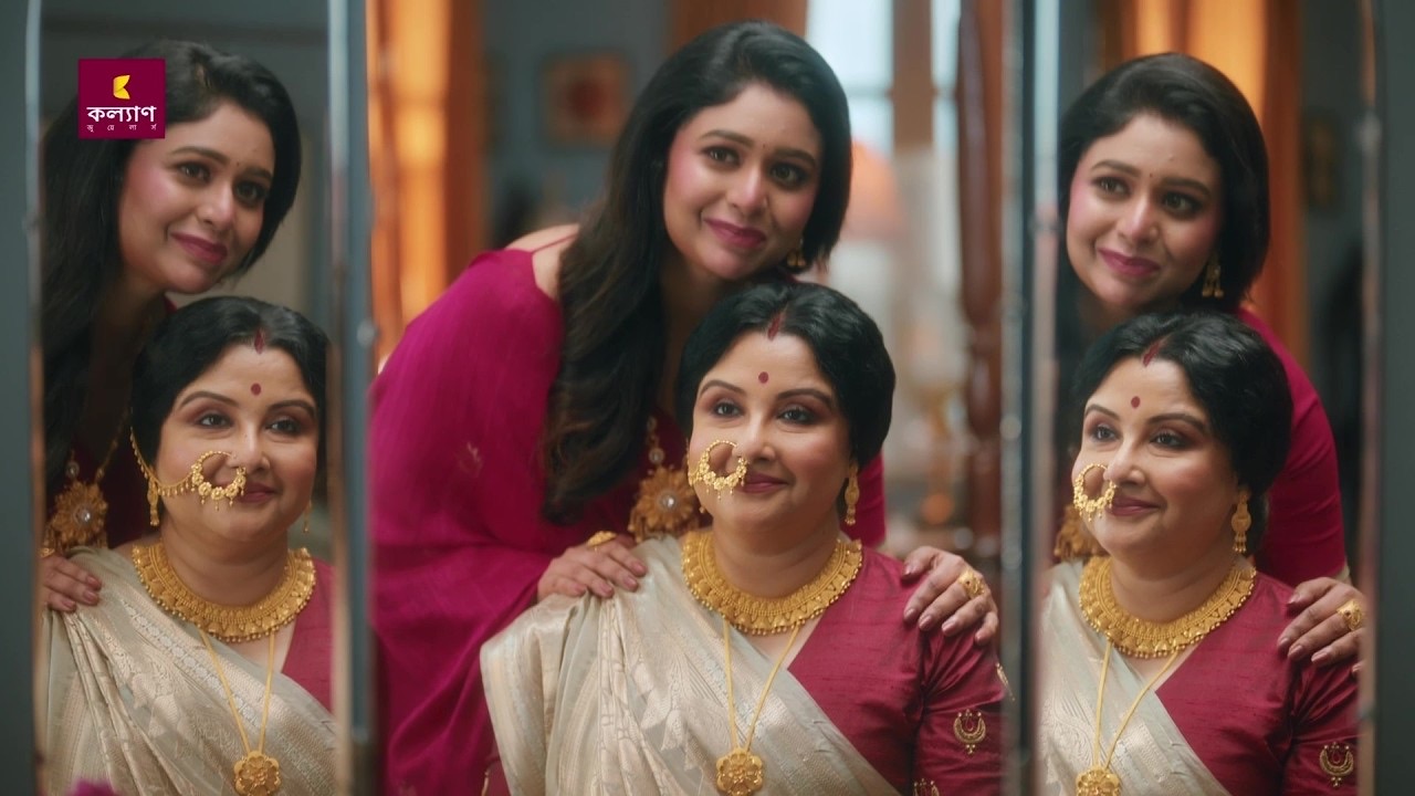 Three generations of women in white and red saris and gold jewellery pose together in front of mirrors, Kalyan Jewellers Durga Pujo 2026