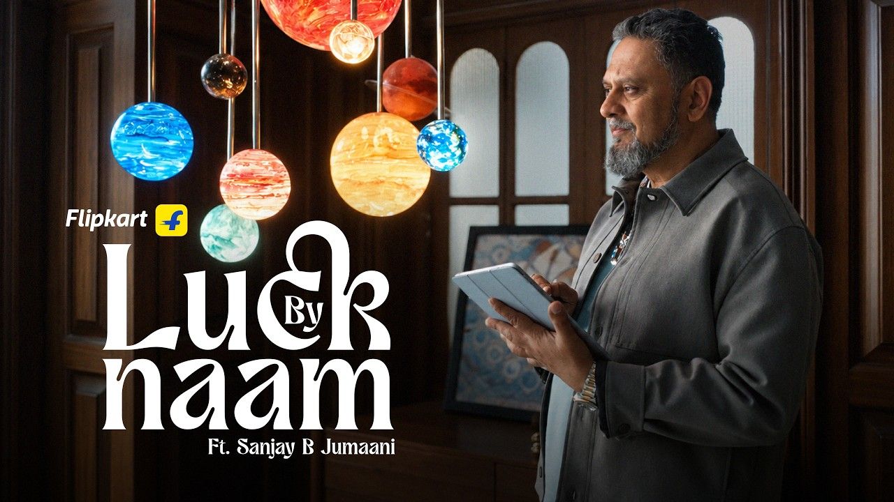 Sanjay B Jumaani holds a tablet beside the "Luck By Naam" title in Flipkart's Big Billion Days 2026 film